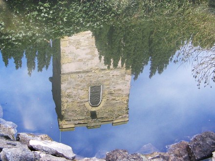Reflection of chuch tower in pond.